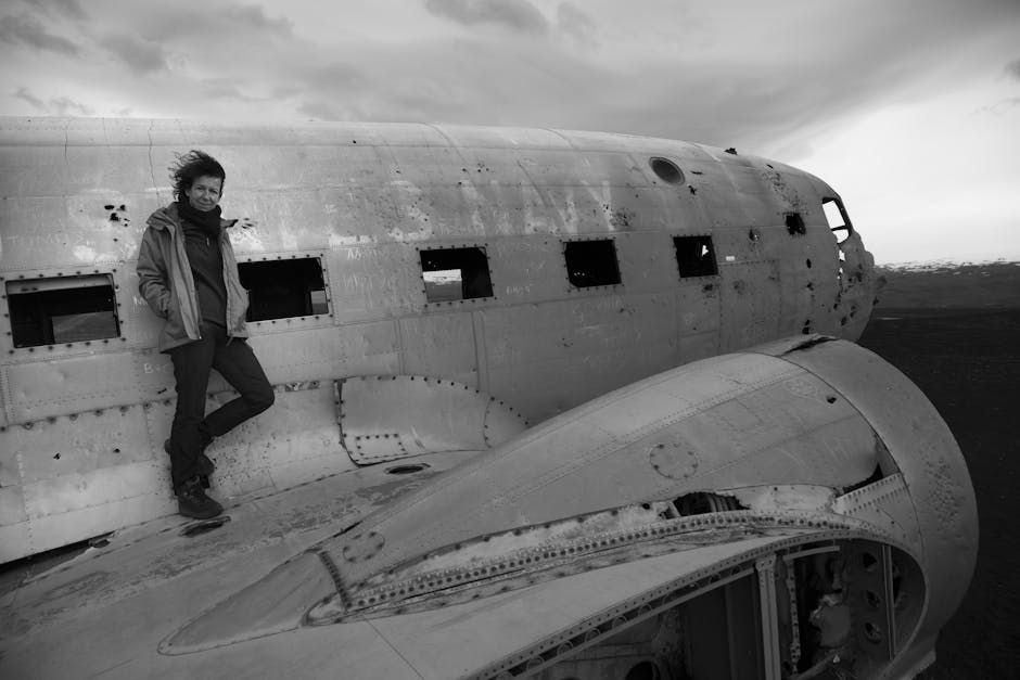 Individual standing on an aircraft wing symbolizing resilience and perspective